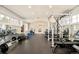 Spacious home gym with mirrored wall, rubber flooring, and an array of weightlifting and cardio equipment at 5425 S University Blvd, Greenwood Village, CO 80121