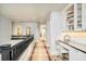 Bright upstairs hallway with views of the stairwell, as well as a built-in desk with custom cabinetry at 5425 S University Blvd, Greenwood Village, CO 80121