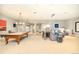 Expansive living room with pool table, ample seating, and projector screen perfect for entertainment at 5425 S University Blvd, Greenwood Village, CO 80121