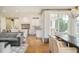 Bright living space flows into an open kitchen featuring white cabinets, a center island, and stylish finishes at 5425 S University Blvd, Greenwood Village, CO 80121