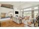 Sun-filled living room featuring a fireplace, comfortable seating, and an open layout connecting to the kitchen and dining area at 5425 S University Blvd, Greenwood Village, CO 80121