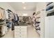 Spacious walk-in closet featuring custom shelving and a center island with ample storage for clothes and accessories at 5425 S University Blvd, Greenwood Village, CO 80121