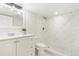 Bathroom features white vanity, marble patterned shower and tile flooring at 18751 E Mexico Ave, Aurora, CO 80017