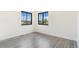 Bedroom featuring natural light from the two windows and light wood-look flooring at 18751 E Mexico Ave, Aurora, CO 80017