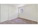 Bedroom features neutral paint, window, closet with doors and neutral carpet at 18751 E Mexico Ave, Aurora, CO 80017