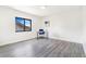 Light and airy bedroom featuring a window with a view, and light wood-look floors at 18751 E Mexico Ave, Aurora, CO 80017