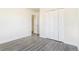 Bedroom featuring light wood-look flooring and closet with bi-fold doors at 18751 E Mexico Ave, Aurora, CO 80017