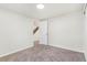 Bedroom features neutral paint and neutral carpet and a door looking out to a staircase at 18751 E Mexico Ave, Aurora, CO 80017