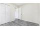Bedroom featuring light wood-look flooring and a closet with bi-fold doors at 18751 E Mexico Ave, Aurora, CO 80017
