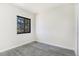 Bedroom featuring light wood-look flooring and a view from the black framed window at 18751 E Mexico Ave, Aurora, CO 80017