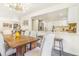 Modern kitchen featuring a breakfast bar that connects the open-concept living and dining areas at 18751 E Mexico Ave, Aurora, CO 80017