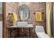 Stylish bathroom with exposed brick, modern sink, and elegant fixtures at 720 16Th St # 505, Denver, CO 80202