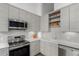 Modern kitchen features stainless steel appliances, granite countertops, and white tile backsplash at 720 16Th St # 505, Denver, CO 80202