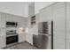 Modern kitchen features stainless steel appliances, sleek cabinetry and stone countertops at 720 16Th St # 505, Denver, CO 80202