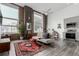 Bright living room features large windows, hardwood floors, exposed brick, and modern decor at 720 16Th St # 505, Denver, CO 80202