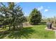 Serene backyard with a well-maintained lawn, a wooden fence, and outdoor cooking area, offering a private retreat at 11037 Cambridge Pl, Parker, CO 80138