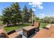 Inviting outdoor patio with comfortable seating surrounded by lush trees, creating a serene backyard escape at 11037 Cambridge Pl, Parker, CO 80138