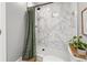 Shower with marble tile surround and a teak floor at 11037 Cambridge Pl, Parker, CO 80138