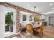 Inviting dining area with exposed brick accent wall, built-in bench seating, and backyard views at 11037 Cambridge Pl, Parker, CO 80138