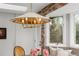 Cozy dining room featuring exposed brick accent wall, plush window bench, and vintage lighting at 11037 Cambridge Pl, Parker, CO 80138