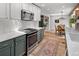 Stylish kitchen with white countertops, green cabinets, and dining area in background at 11037 Cambridge Pl, Parker, CO 80138