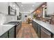 Modern kitchen featuring stainless steel appliances, green cabinets, and an exposed brick accent wall at 11037 Cambridge Pl, Parker, CO 80138