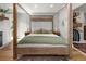 Warm bedroom featuring a wooden four poster bed and a door to the outside at 11037 Cambridge Pl, Parker, CO 80138