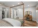 Bright main bedroom featuring a four-poster bed, a walk-in closet, and a vanity at 11037 Cambridge Pl, Parker, CO 80138