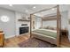 Spacious main bedroom featuring a canopy bed, fireplace, and hardwood floors at 11037 Cambridge Pl, Parker, CO 80138