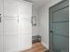 Mudroom with storage cabinets and seating near green door at 11037 Cambridge Pl, Parker, CO 80138