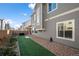 Backyard with grass, fence, rock landscaping, and gray siding at 10226 Worchester St, Commerce City, CO 80022