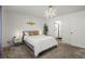 Bright bedroom with white walls, statement lighting, and ensuite bathroom at 10226 Worchester St, Commerce City, CO 80022