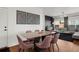 Dining area flowing into a living room with a sleek modern dining table and views of the home's interior at 10226 Worchester St, Commerce City, CO 80022