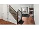 Inviting entryway featuring hardwood floors, a staircase, and an open view into the cozy living room at 10226 Worchester St, Commerce City, CO 80022