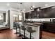 Modern kitchen featuring dark cabinetry, granite countertops, an island with bar seating, and stainless steel appliances at 10226 Worchester St, Commerce City, CO 80022