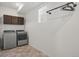 Spacious laundry room with modern washer and dryer, ample cabinet space, and functional design at 10226 Worchester St, Commerce City, CO 80022