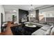 Modern living room with a large sectional sofa, black accent wall, and natural light at 10226 Worchester St, Commerce City, CO 80022