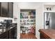 Walk-in pantry with ample shelving, providing plenty of storage space next to the modern kitchen appliances at 10226 Worchester St, Commerce City, CO 80022