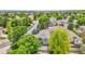 Aerial view of a home nestled among lush green trees in a quiet neighborhood at 10571 Garfield St, Thornton, CO 80233