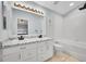 Bathroom features double sink vanity with marble countertop, bathtub, and tiled shower at 10571 Garfield St, Thornton, CO 80233