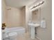 Neutral toned bathroom featuring a pedestal sink and shower-tub combination at 10571 Garfield St, Thornton, CO 80233
