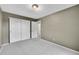 Neutral bedroom showcases a closet and a carpeted floor at 10571 Garfield St, Thornton, CO 80233