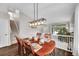 Elegant dining room featuring hardwood floors, modern lighting, and staircase access at 10571 Garfield St, Thornton, CO 80233