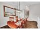 Elegant dining room with hardwood floors, modern lighting, and staircase access at 10571 Garfield St, Thornton, CO 80233