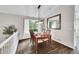 Dining room with dark wood floors, elegant lighting, and large mirror at 10571 Garfield St, Thornton, CO 80233