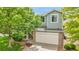 Charming two-story home featuring a well-maintained lawn and attached garage at 10571 Garfield St, Thornton, CO 80233