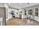 Modern kitchen boasts stainless steel appliances, bright white cabinetry, and an eat-in breakfast nook at 10571 Garfield St, Thornton, CO 80233