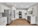 Modern kitchen featuring stainless steel appliances and white cabinetry at 10571 Garfield St, Thornton, CO 80233