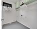 Clean, functional laundry room with shelving and a utility sink hookups at 10571 Garfield St, Thornton, CO 80233