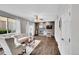 Comfortable living room with hardwood floors, a fireplace, and ample natural light at 10571 Garfield St, Thornton, CO 80233